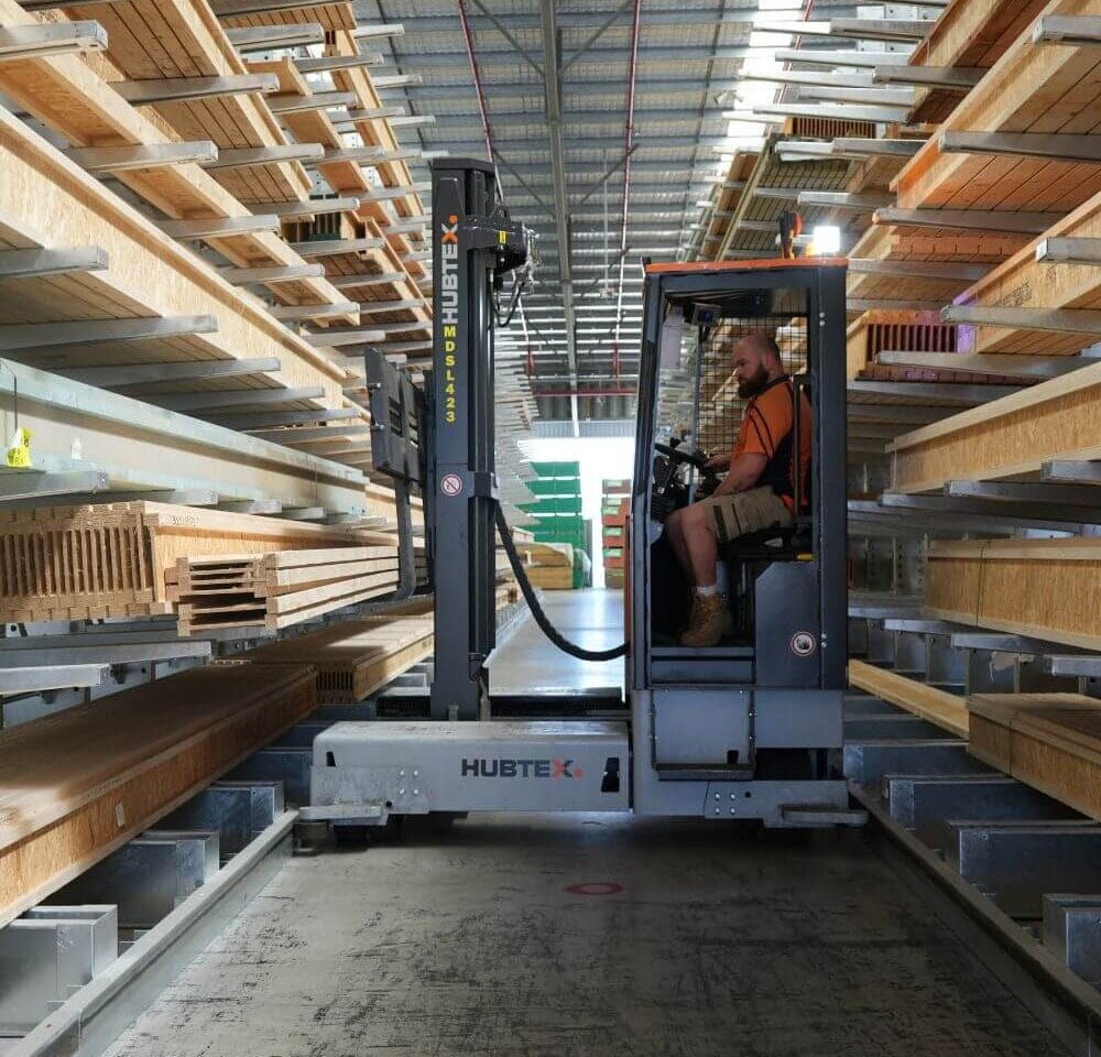 Sideloader forklifts working in narrow aisle