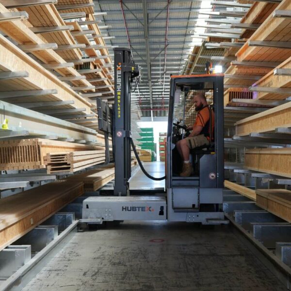 Sideloader forklifts working in narrow aisle