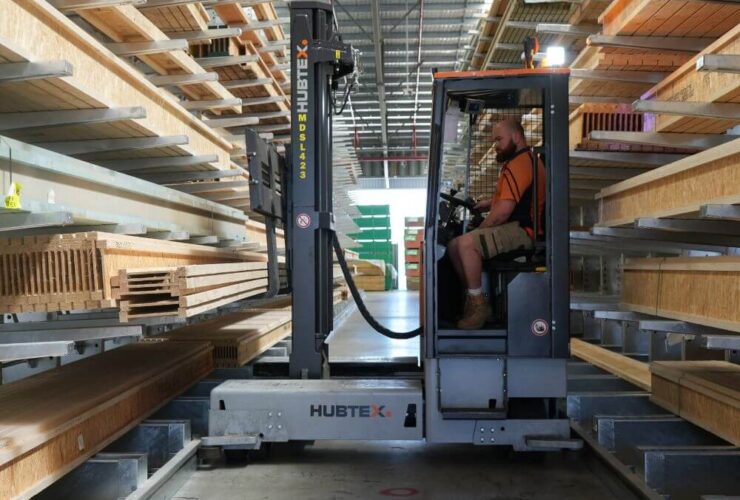 Sideloader forklifts working in narrow aisle